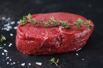 Raw meat with spices and herbs on table