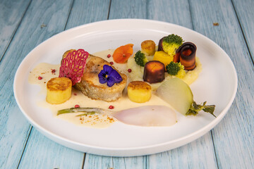 Recipe of cod steak, mashed potatoes and its farandole of vegetables, parsnip, turnip, broccoli, candied potato. High quality photo