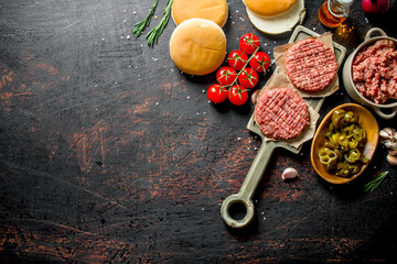 Raw burgers with jalapeno chillies, tomatoes and scones.
