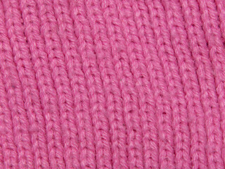 Pink texture knitted wool background. Fabric structure with natural texture. Fabric background. Knitted wool background