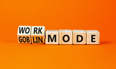 Work or goblin mode symbol. Concept word Work mode Goblin mode on wooden cubes. Beautiful orange...
