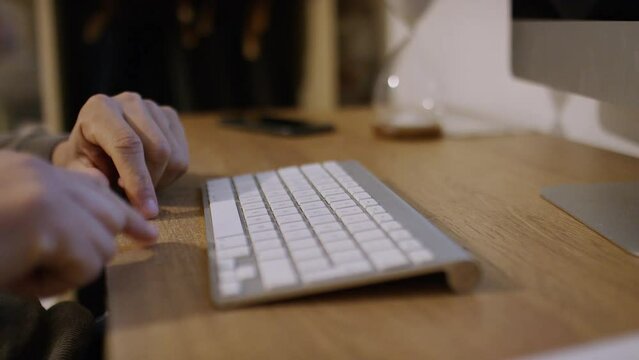 Hands of a male wondering what to type before starting to type with two fingers