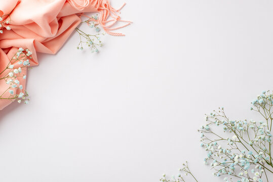 Hello spring concept. Top view photo of pink scarf and gypsophila flowers on isolated white background with copyspace