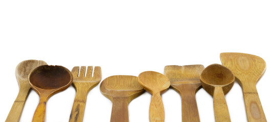 Different old used wooden spoons isolated on white background