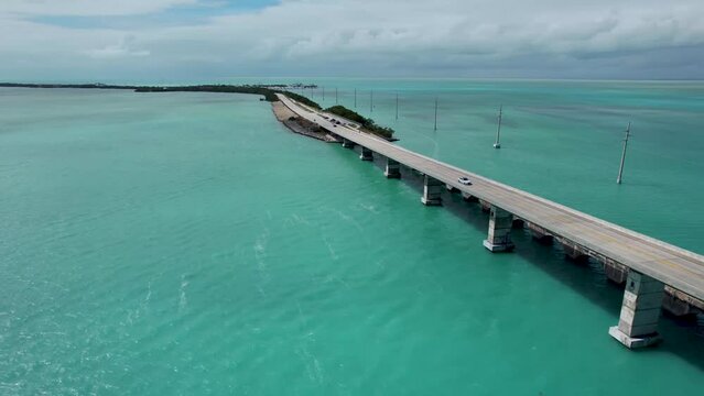 Over seas highway Florida keys bridge, aerial panning view with blue water