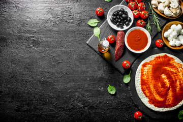 Preparation pizza. Dough with different ingredients for cooking pizza.