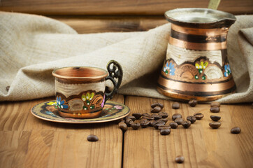 Traditional Turkish coffee set: vintage copper cup with coffee turk and roasted coffee beans on...