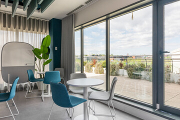 A coworking office with rest tables next to a terrace with views