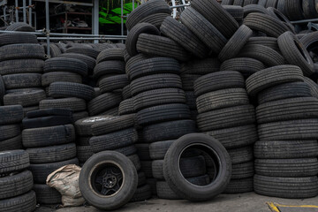 Old black car tires are piled up. tires abandoned in a junkyard It is prepared for recycling.