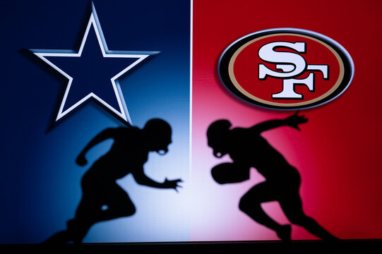 SAN FRANCISCO, USA, JANUARY 18, 2023: Dallas Cowboys vs. San Francisco 49ers. NFL Divisional Round 2023, Silhouette of two NFL American Football Players against each other. Big screen in background
