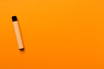 Disposable electronic cigarette on color background, top view