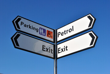 Fototapeta premium Close Up of Sign Post seen against Blue Sky