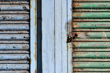 Close Up of Old Rusty Metal Roller Shutters  on Derelict Building 
