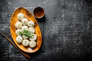 Freshly cooked dumplings manta on a plate with rosemary.
