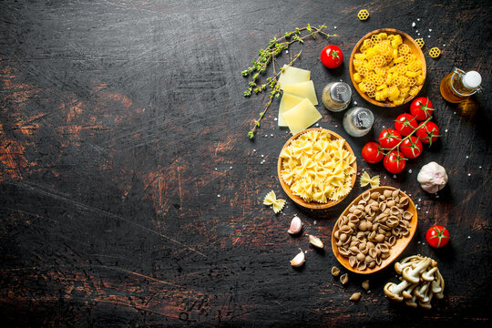 Different types of raw paste with thyme, tomatoes and mushrooms.