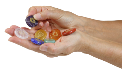 Female holding and offering chakra symbol etched healing stones cutout for crystal therapy holistic theme