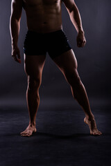 Obraz premium Handsome muscular shirtless young man standing confident, front view, looking at camera