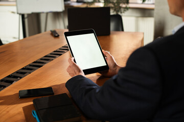 Close up of man using digital tablet.