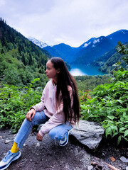 a woman in the mountains on a lake inspiration nature creativity tranquility meditation of peace relaxation rest - 562408191