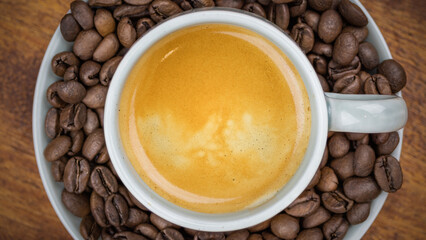 Espresso Coffee surrounded by beans macro