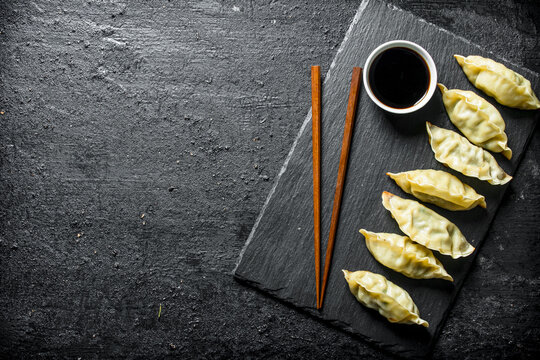 Chinese gedza dumplings on a black stone Board.