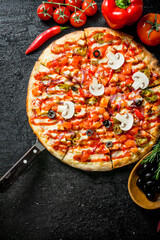 Pizza with olives, sausages and tomatoes.