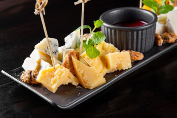 Cheese plate on Dark wooden background