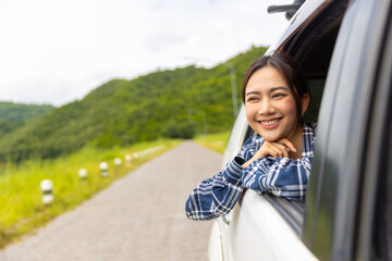 Young Asian woman enjoy outdoor lifestyle road trip and camping in forest mountain on summer travel...