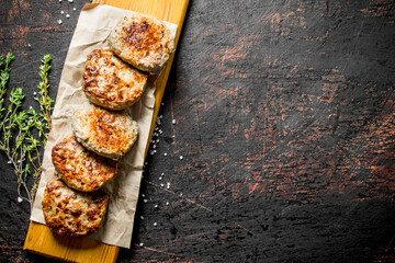 Cutlets on paper with thyme.