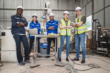 Portrait African American and caucasian engineer with arm robot at factory © chachamp