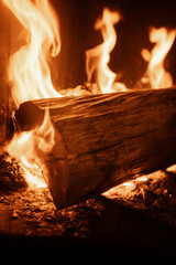 Log of wood burning in a fireplace inside a house, hearth