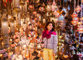 Woman looking at Turkish lamps