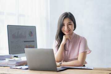 Asian businesswoman working with calculator to analyze business data and financial concept Female...