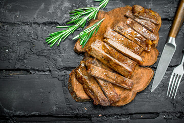 Grilled sliced beef steak with rosemary.