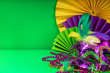 Mardi Gras colourful holiday greeting card background with festival masquerade accessories, decor,...