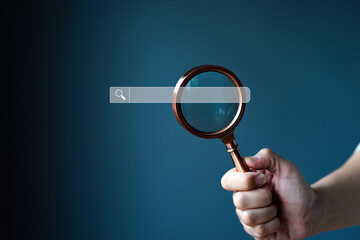 Woman holding magnifying glass on background, close-up. Search keyword concept.