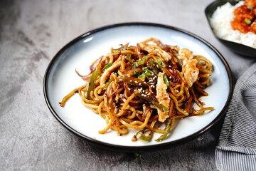 Chicken Lo mein noodles topped with toasted sesame seeds and spring onions