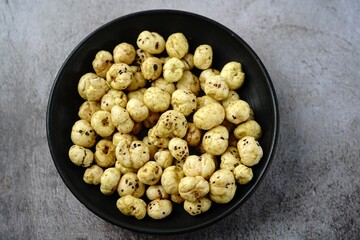 Makhana, also called as Lotus Seeds or Fox Nuts are popular dry snacks from India, served in a bowl.