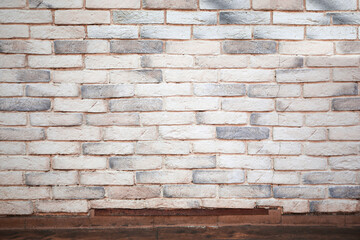 View on white brick wall and wooden floor