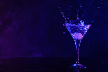 Martini splashing out of glass in neon lights, space for text