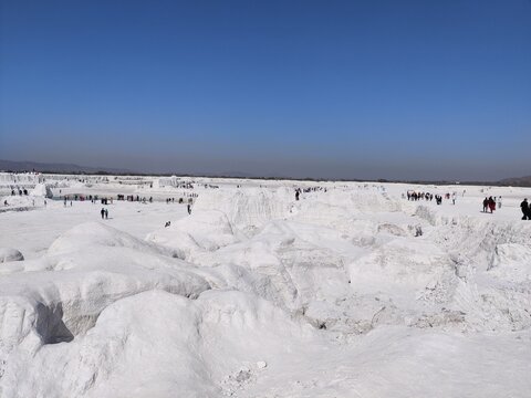 Picture of panoramic view of snow covered field with blue sky shot during daylight. Ice desert