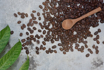 Coffee beans and green leaves from top view