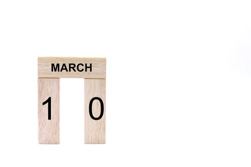 March 10 displayed wooden letter blocks on white background with space for print. Concept for calendar, reminder, date. 