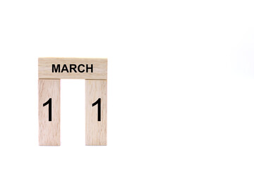 March 11 displayed wooden letter blocks on white background with space for print. Concept for calendar, reminder, date. 