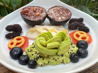 Mashed avocado with mixed multi grain and fruits