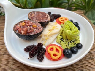 Mashed avocado with mixed multi grain and fruits