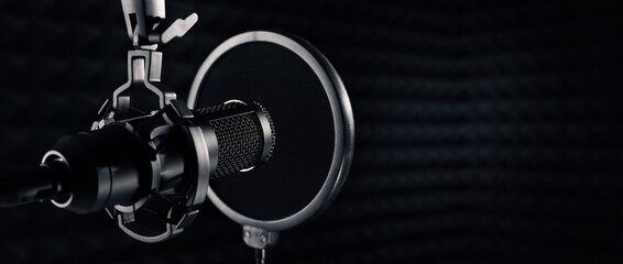microphone in dark sound recording studio. banner with copy space