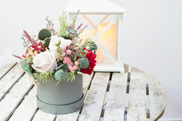 beautiful delicate bouquet of stabilized flowers, roses,dried flowers, branches of leaves and on a rustic table in interior ,selective focus.gift bouquet for valentine.gift for mother day