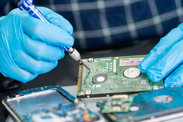 Technician repairing inside of mobile phone by soldering iron. Integrated Circuit. the concept of data, hardware, technology.