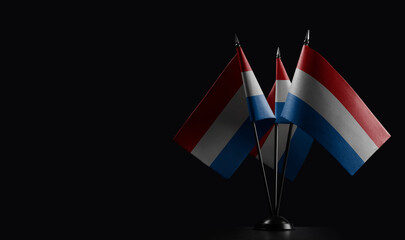 Small national flags of the Netherlands on a black background